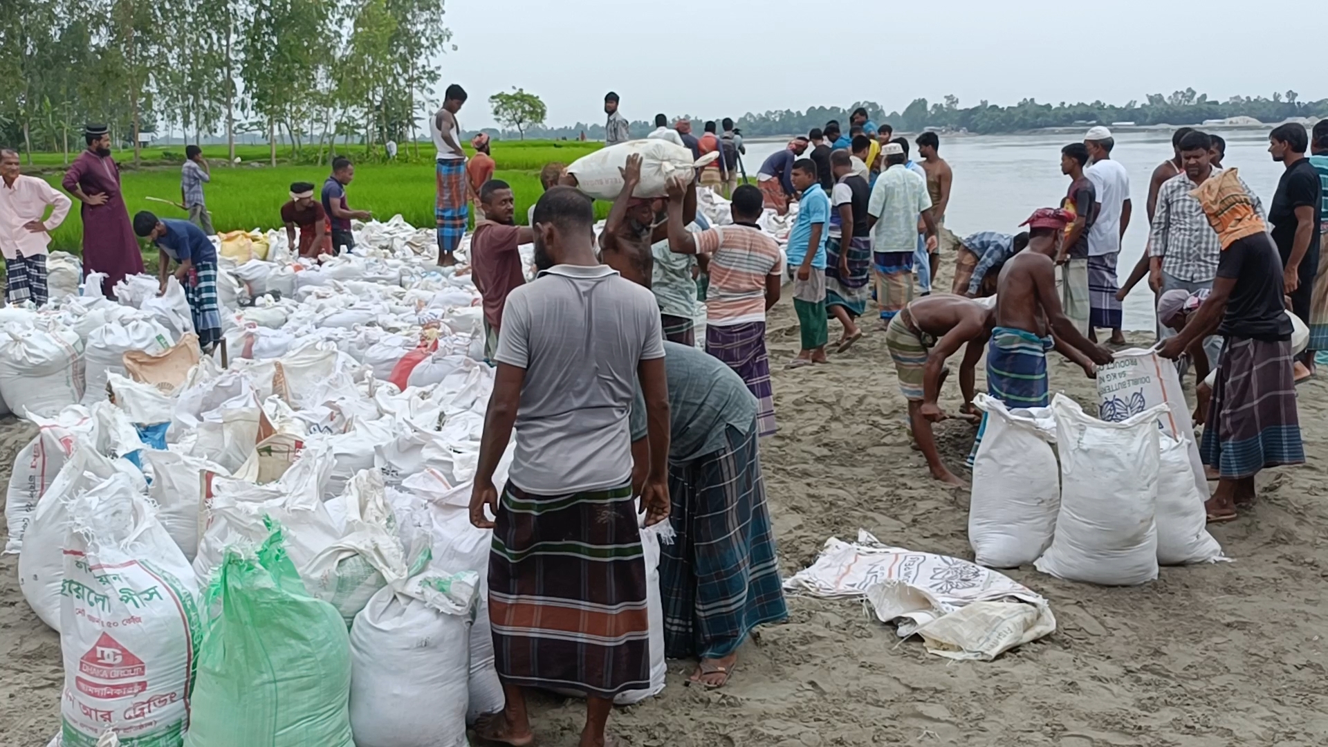 Villagers try to prevent erosion by volunteering to protect their houses and cropland
